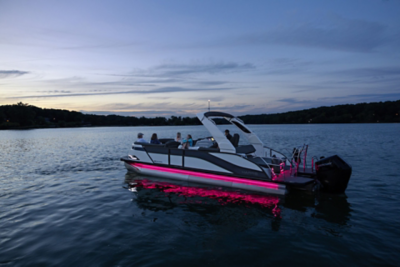 Harris Grand Mariner cruising at night with pink lights showing.