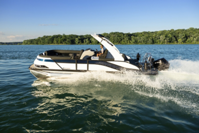 Harris Grand Mariner pontoon boat speeding across a large body of water, creating a significant wake behind it.