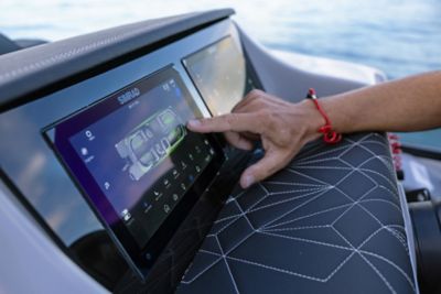 Finger utilizing the touch dual screens on the Simrad technology on the Harris Pontoon Boat.