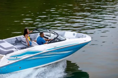 couple riding in a blue VR5 Bowrider boat