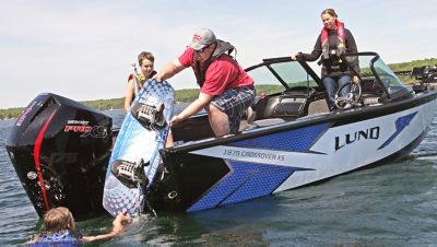 Family of Four Wake Boating on Lund 1875 Crossover XS Fish and Ski Boat