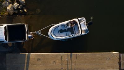Two Men Launching Bayliner Bowrider Boat with Trailer