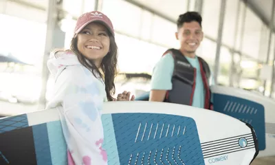 girl and boy with surfboards