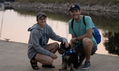 Couple with dog on the dock