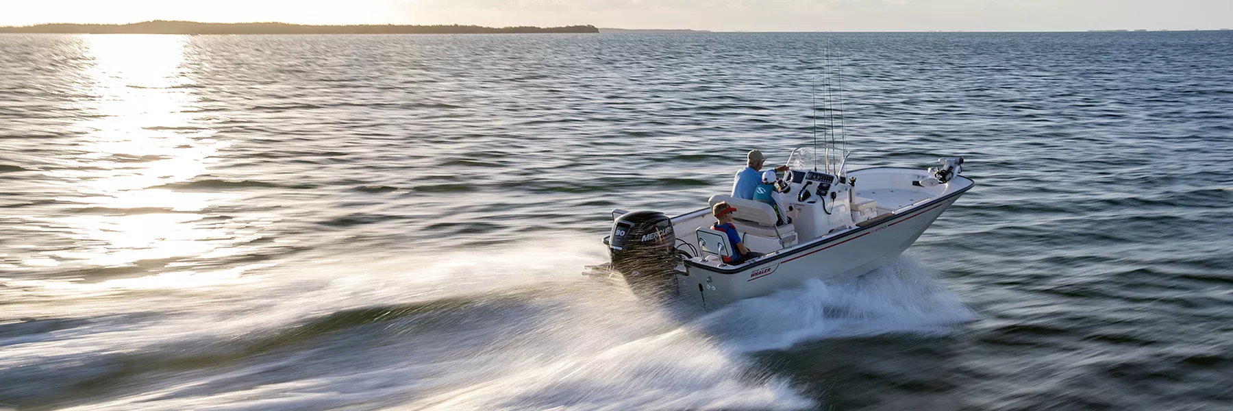 people riding a boston whaler on the ocean