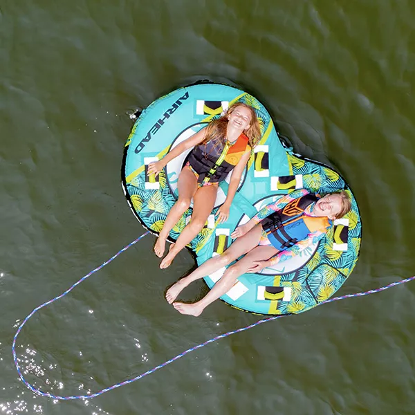 Two girls floating on a tube