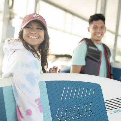 girl and boy with surfboards