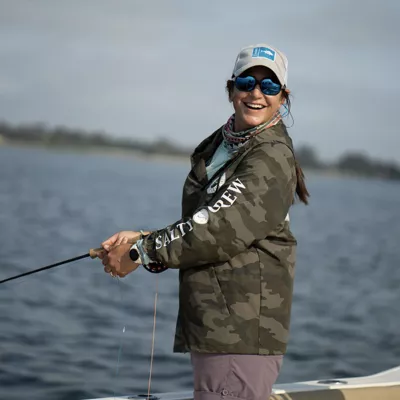 woman fishing on a pier