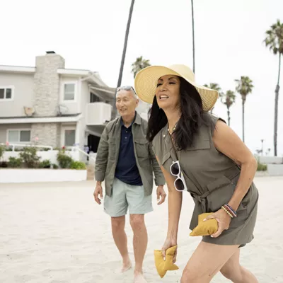 Couple playing cornhole on the beach