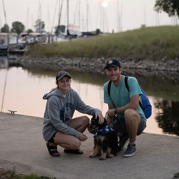 Couple with dog on the dock