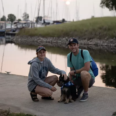 couple with dog on the dock