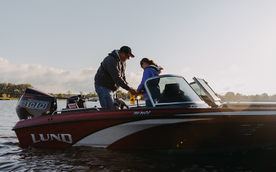 Man Woman Mercury Racing 300r Outboard Motor red and white Lund boat