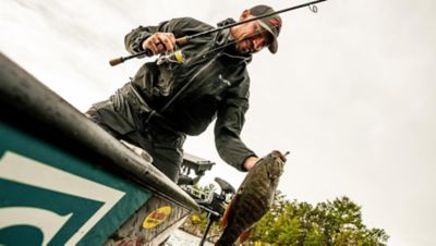 Fisherman placing fish in livewell