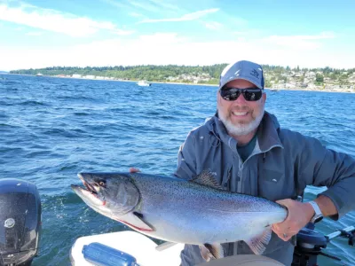 man with fish caught on port of edmonds lake