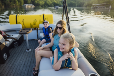 Mother, Son and Daughter Sitting in Lowe Pontoon Boat, Boat Underway on Lake