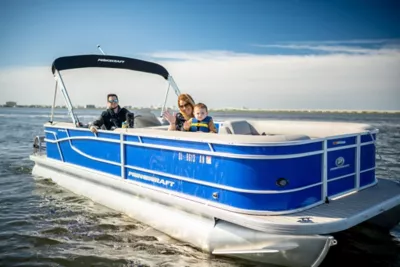 family on pontoon boat in somers point harbor cover marina