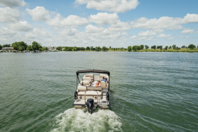 Harris Sunliner 210 running on the water with trees in the background.