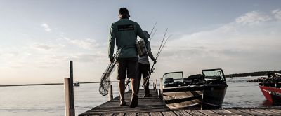 Fishing boat stern deck with trolling fishing rods and reels Stock