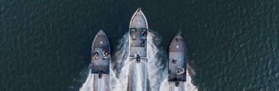 A family of Crestliner boats in deep water, moving in formation.
