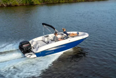 a couple in a blue running Element E16 deck boat