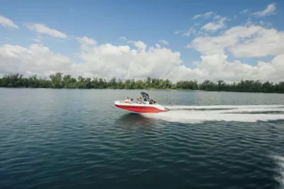 Red Bayliner Boat Running with People