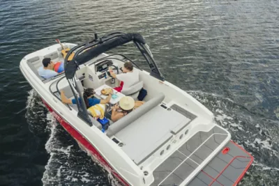 People Sitting in Bayliner deck boat relaxing and cruising along