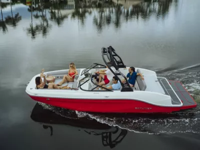 People Sitting in Bayliner deck boat relaxing and cruising along