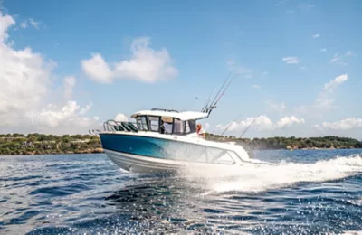 Bayliner Pilothouse Fishing Boat Underway with Driver and Passenger Onboard