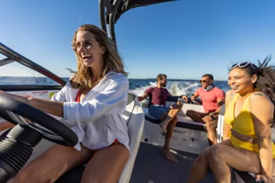 Man Standing on Bow at Bayliner Trophy Center Console Fishing Boat Reeling in Fish