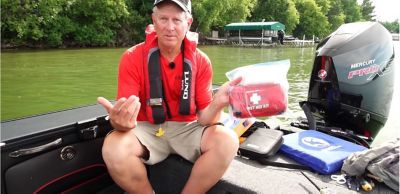 Man Sitting on Fishing Boat with Safety Kit