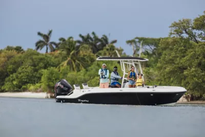 Man Standing on Bow at Bayliner Trophy Center Console Fishing Boat Reeling in Fish