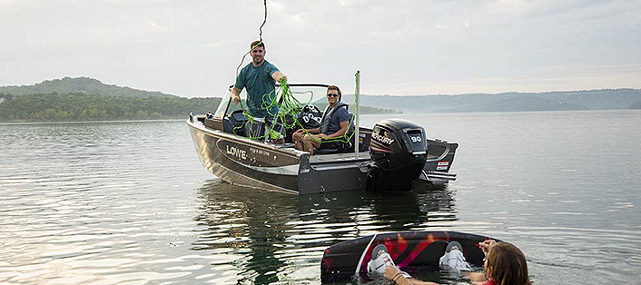 Wakeboarder Getting Ready to Be Towed on a Fish and Ski Boat