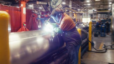 Welder working on a boat chassis for Harris pontoons