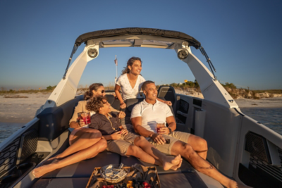 Family on the lounger of a 2024 Harris Crowne 250 Pontoon Boat