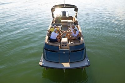 Friends clinking drinks on a Harris Pontoon.