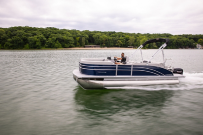 Man driving on a Harris pontoon boat