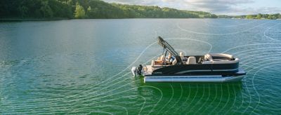 Aerial view of a Harris pontoon boat on calm water.