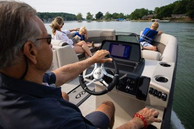 Man driving family on a Harris Sunliner