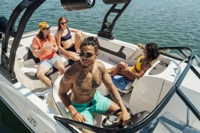 Man Standing on Bow at Bayliner Trophy Center Console Fishing Boat Reeling in Fish