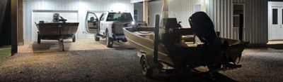 A Lowe boat trailerd in front of a garage