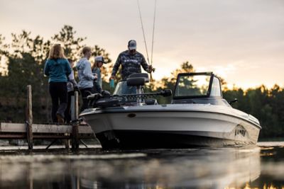 Family of Four Boarding LUND Impact GL 185 Fish and Ski Boat