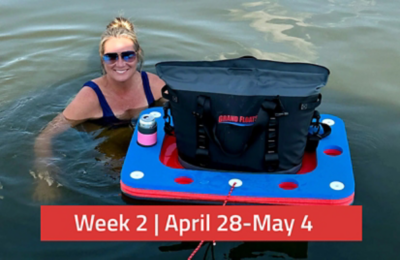 Woman posing with the Grand Floats Water Table and Cooler combo in the water. There is a text overlay saying, "Week 2 | April 28 - May 4."