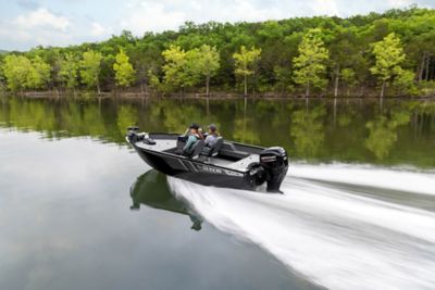 Lowe FM 1675 SC running across the water with greenery behind.