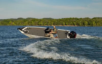 Fisherman Driving Lowe Stinger 198 Aluminum Bass Boat on Lake, Stern View
