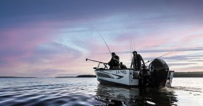 Friends fishing from a Lund on a lake