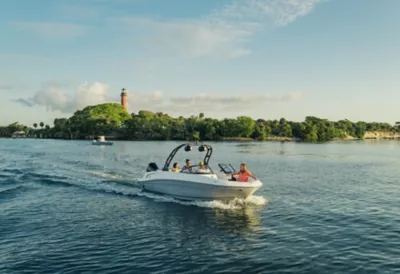 Man Standing on Bow at Bayliner Trophy Center Console Fishing Boat Reeling in Fish