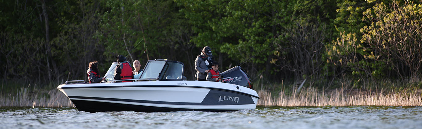 Family of 5 Fishing on Lake in Lund Dual Console Boat, Port-side, Bow View