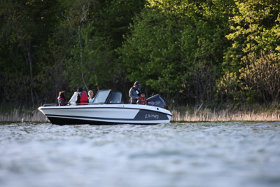 Family of 5 Fishing on Lake in Lund Dual Console Boat, Port-side, Bow View