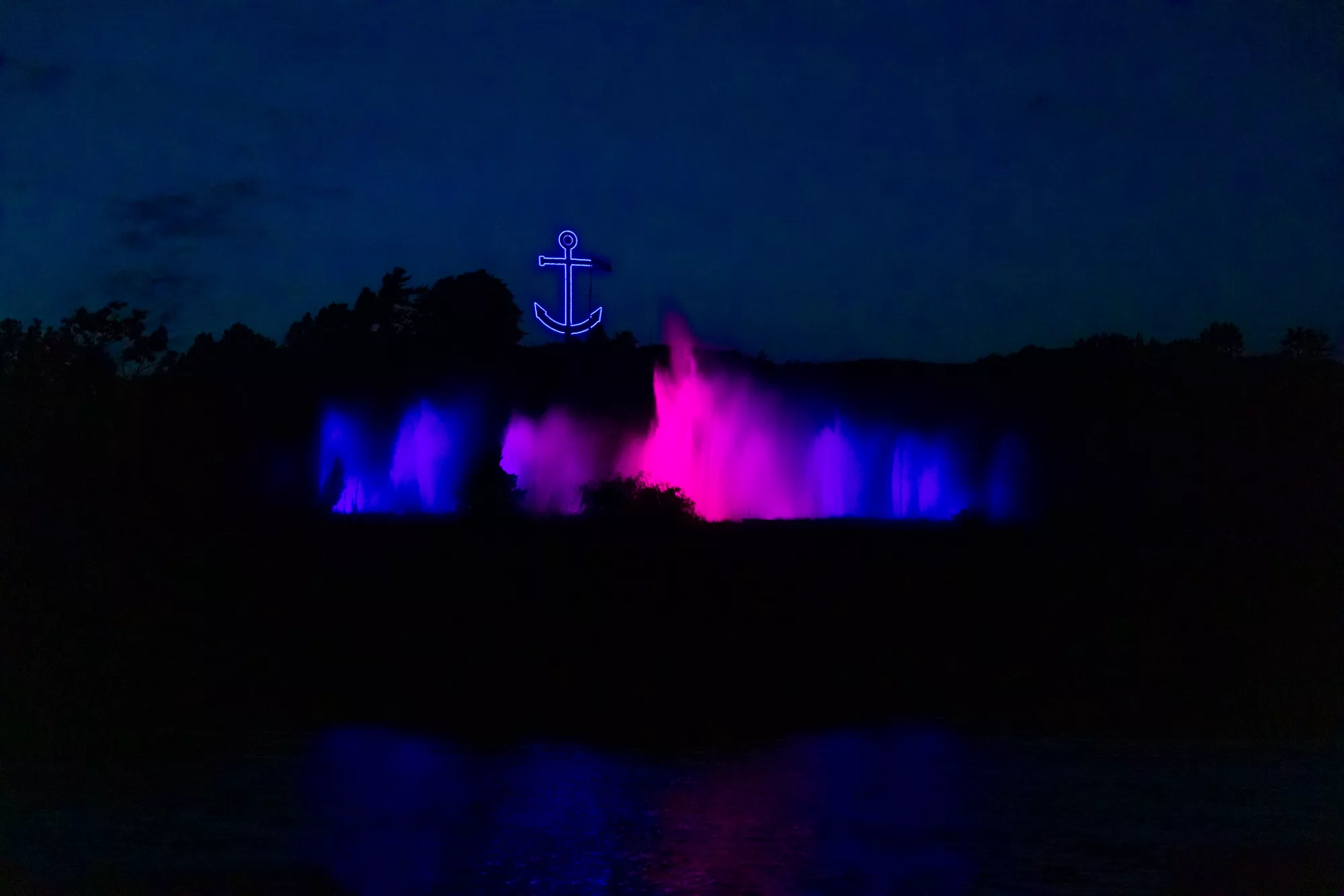 musical fountain in grand haven lit up at night